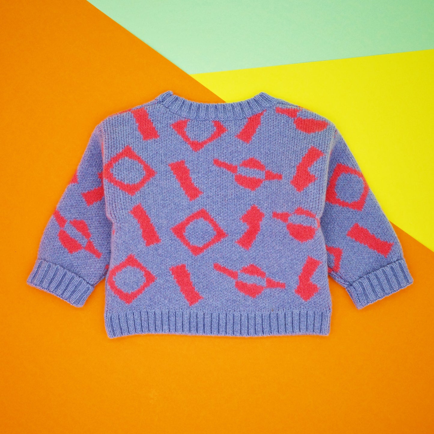 Blue and coral jacquard knit cardigan for children.