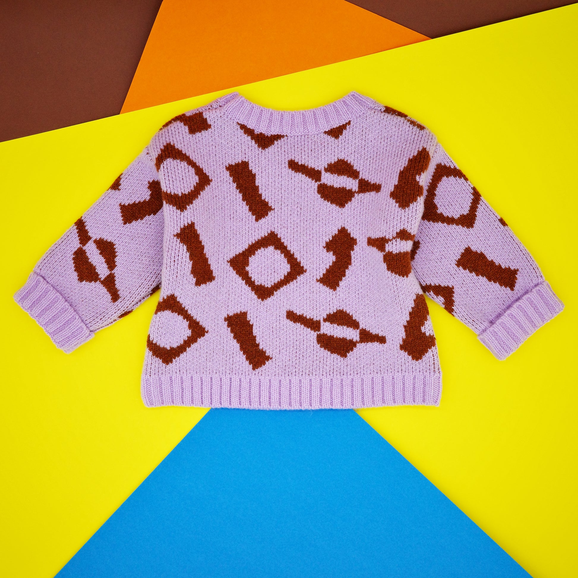 Back of lilac and brown baby jumper in wool.